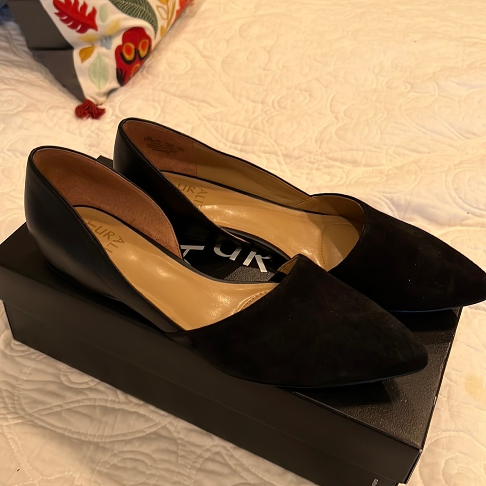 Black flats have suede and leather